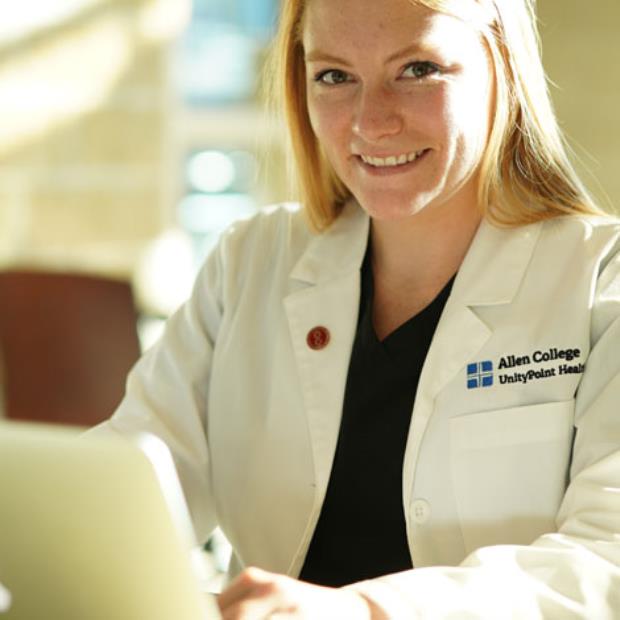 Student in lab coat working